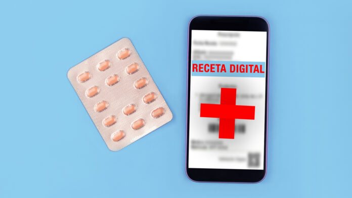 Pill blister and smartphone on blue background.